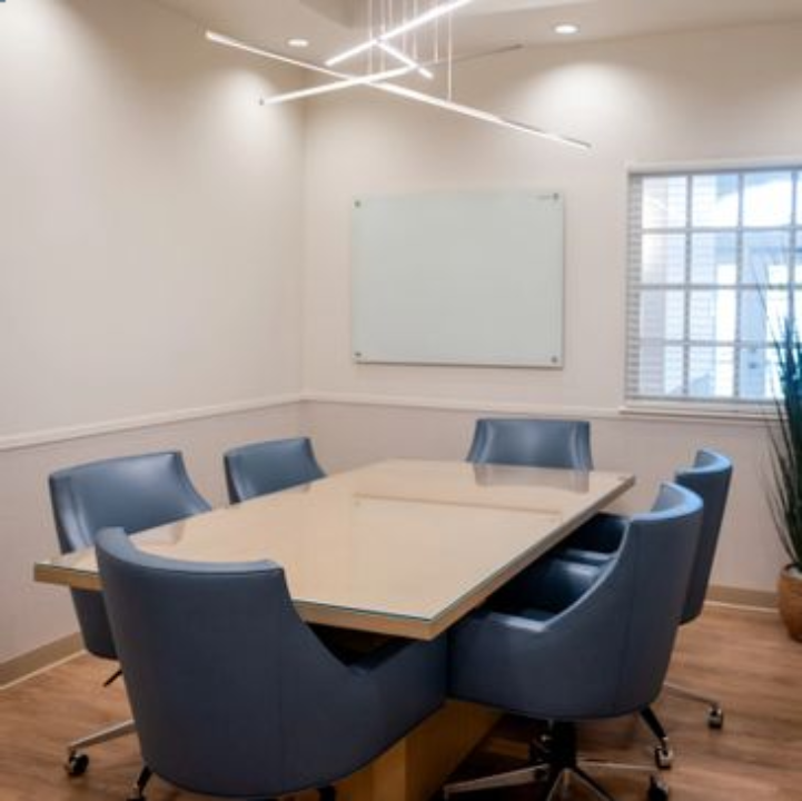 A conference room with six chairs and a table.