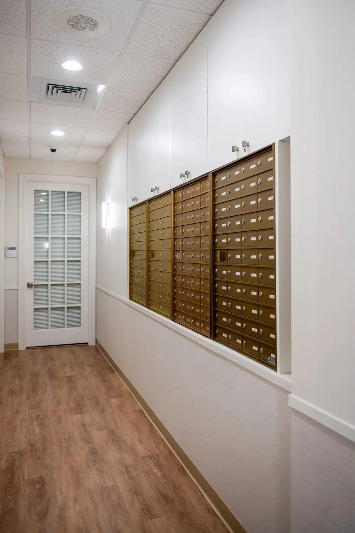 A hallway with many drawers and doors